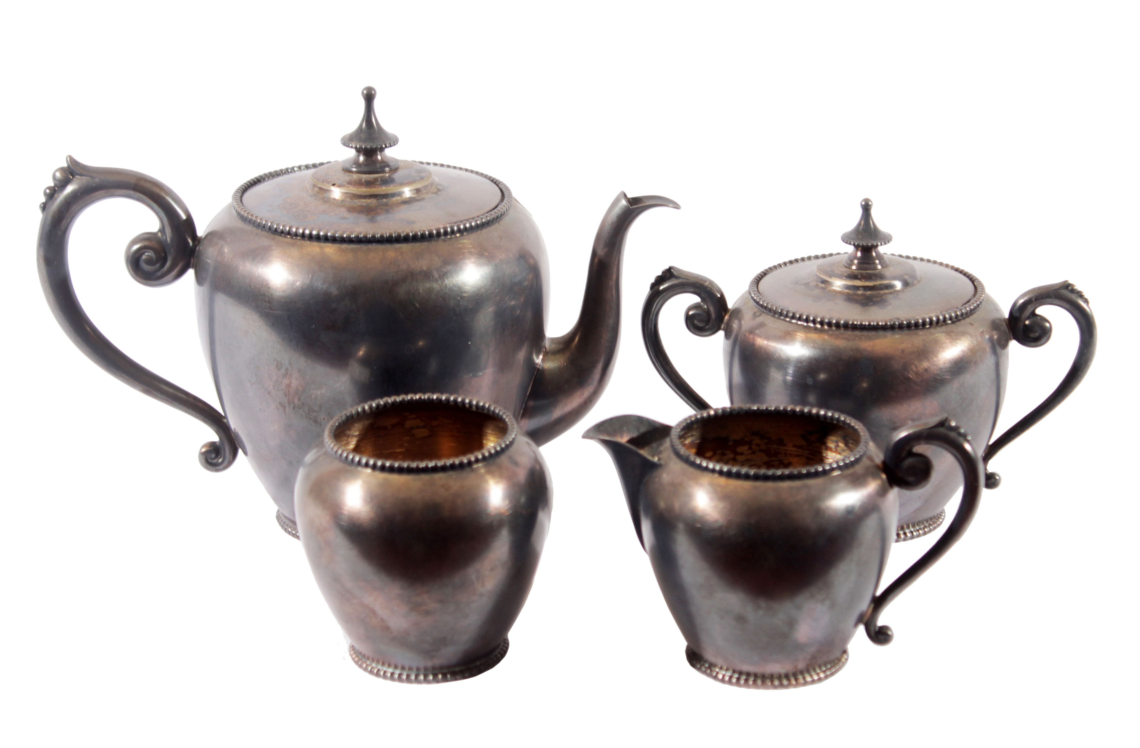 A brass tea set consisting of a tea pot,a sugar pot, two additional containers without lids.