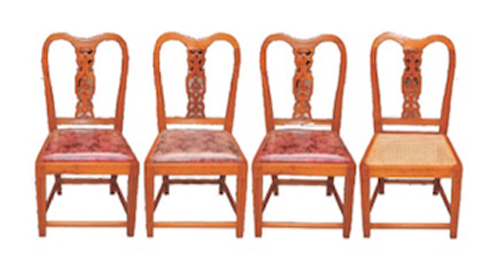 A set of four wooden dining chairs.