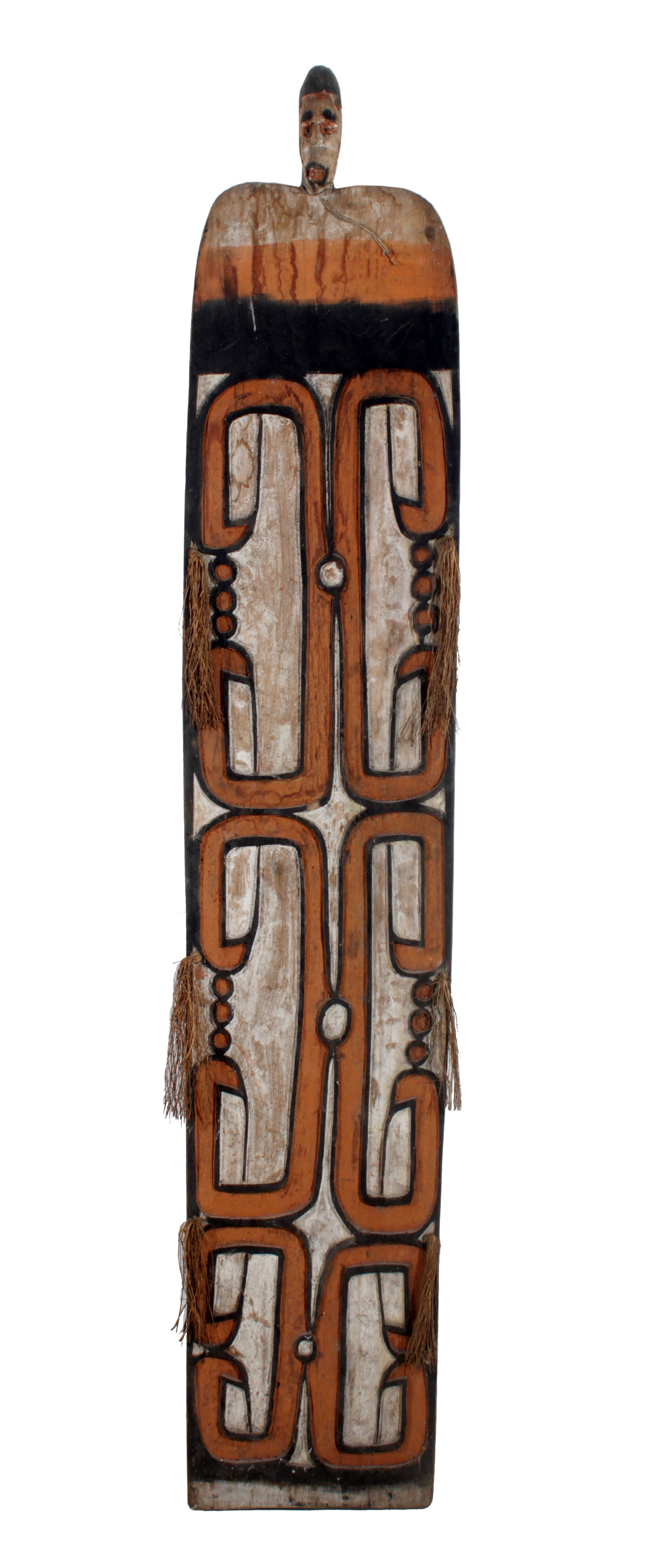 An Asmat wooden shield with head painted in natural dyes.