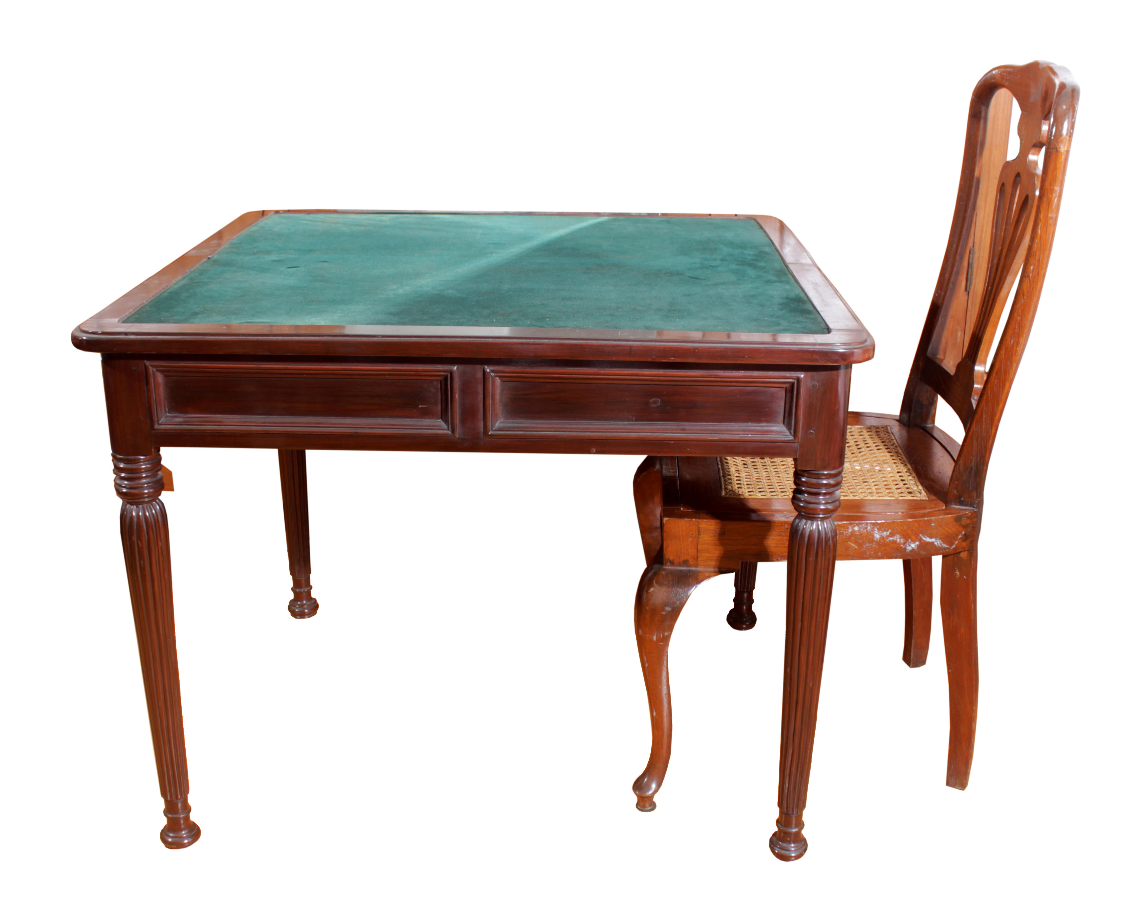 A carved wooden  table with four legs anda wooden chair with rattan seat.