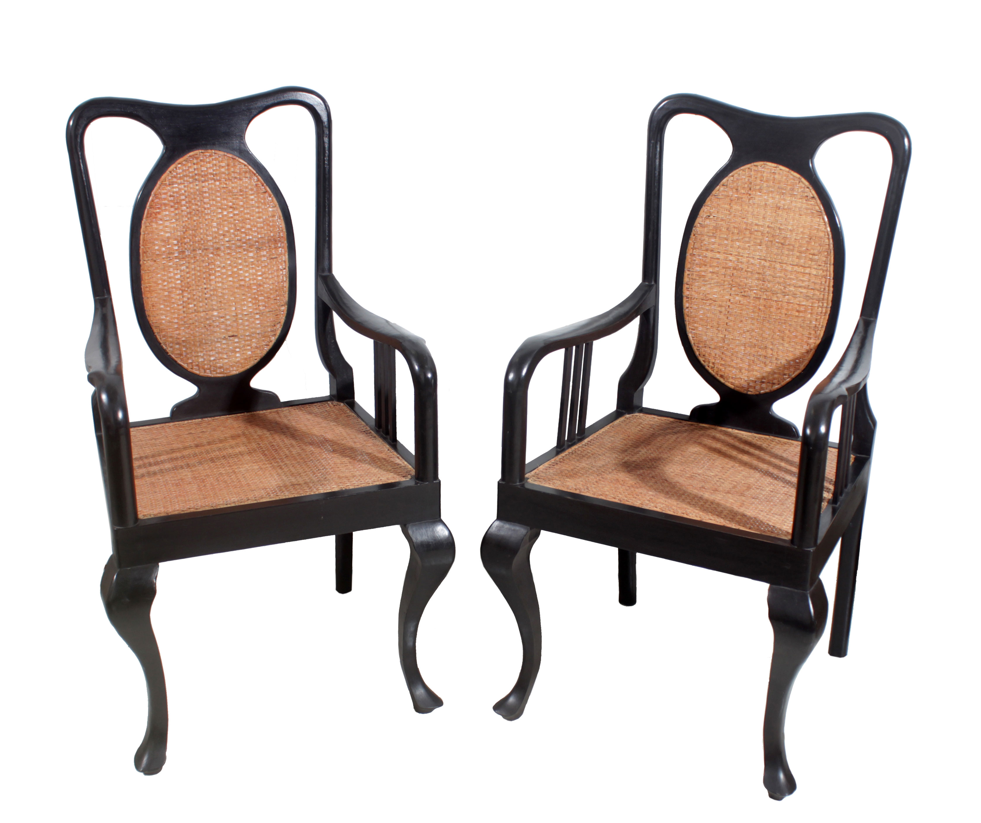 A pair of wooden chairs with rattan backrest and seats.