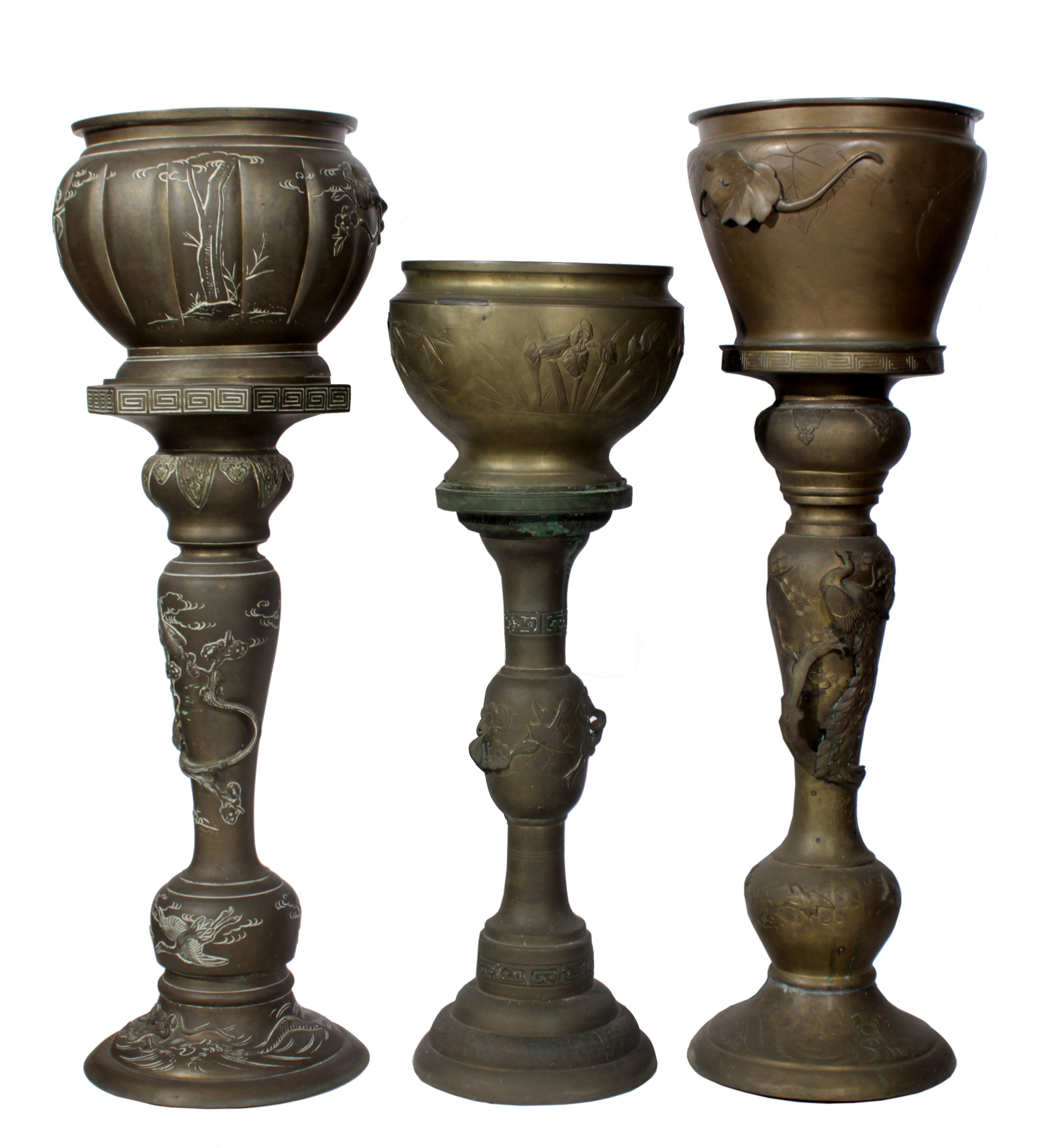 Three brass flower pots and stands.