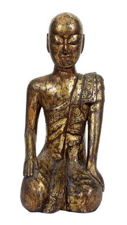 A wooden sculpture of a kneeling monk.