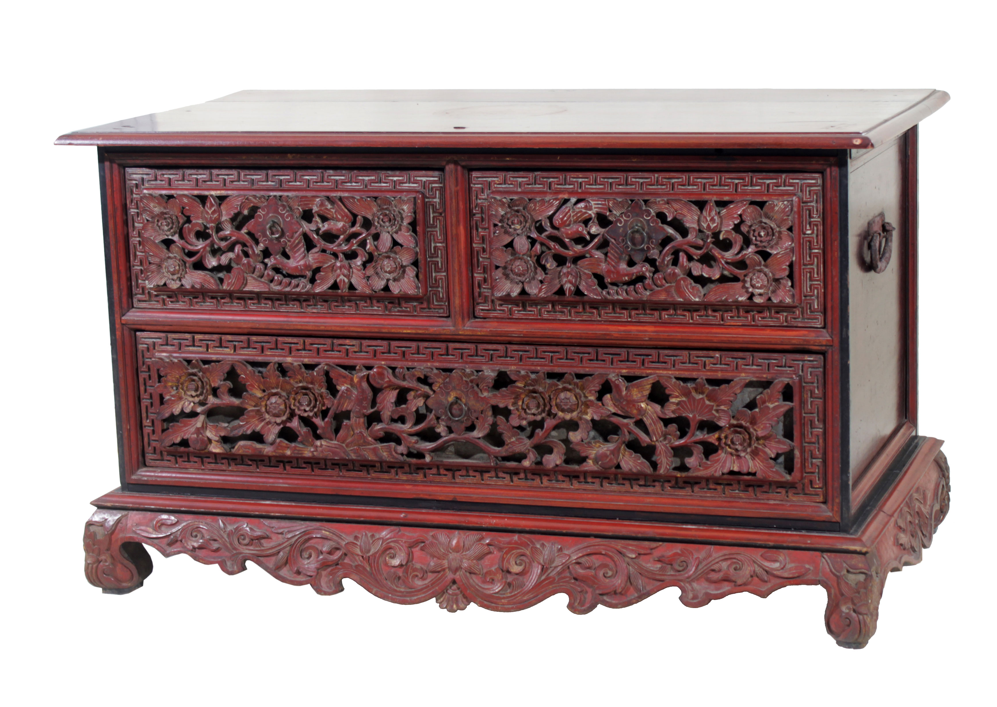 A wooden chest with three drawers and carved decorations.