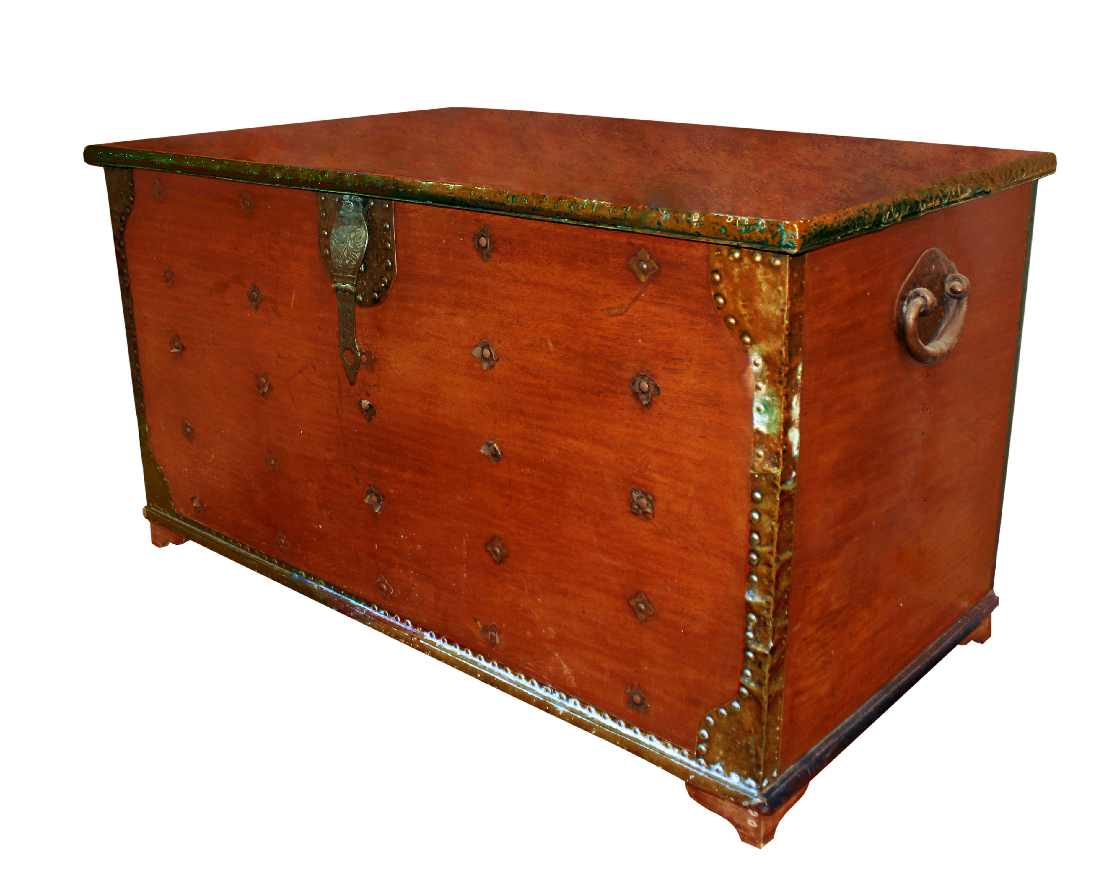 A wooden chest with brass structural supports and embellishments.