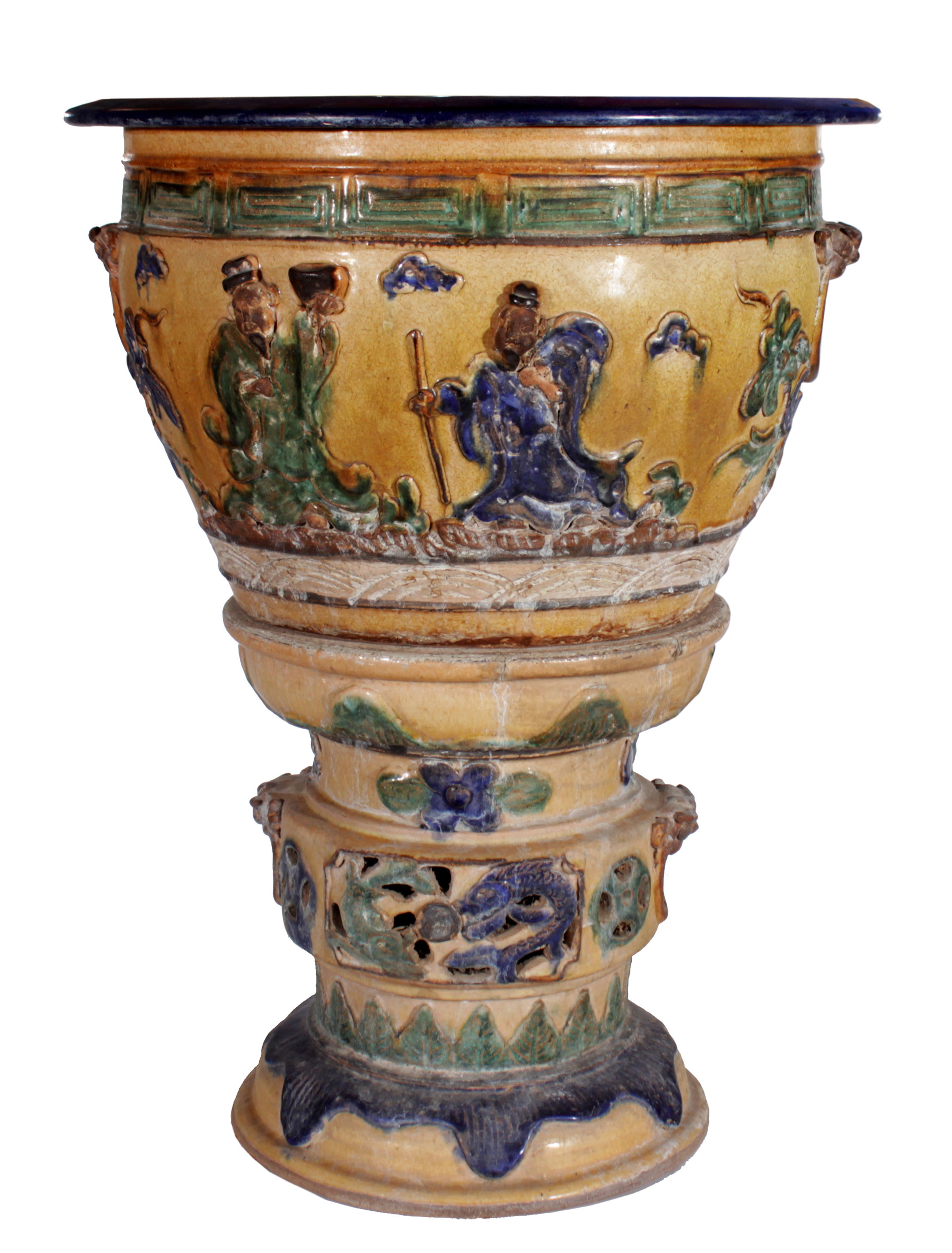 A polychrome flower pot with stand, decorated with figures in relief.