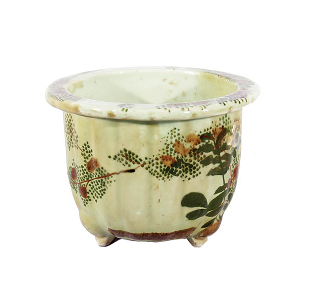 A celadon ceramic planter pot with flower decoration.  