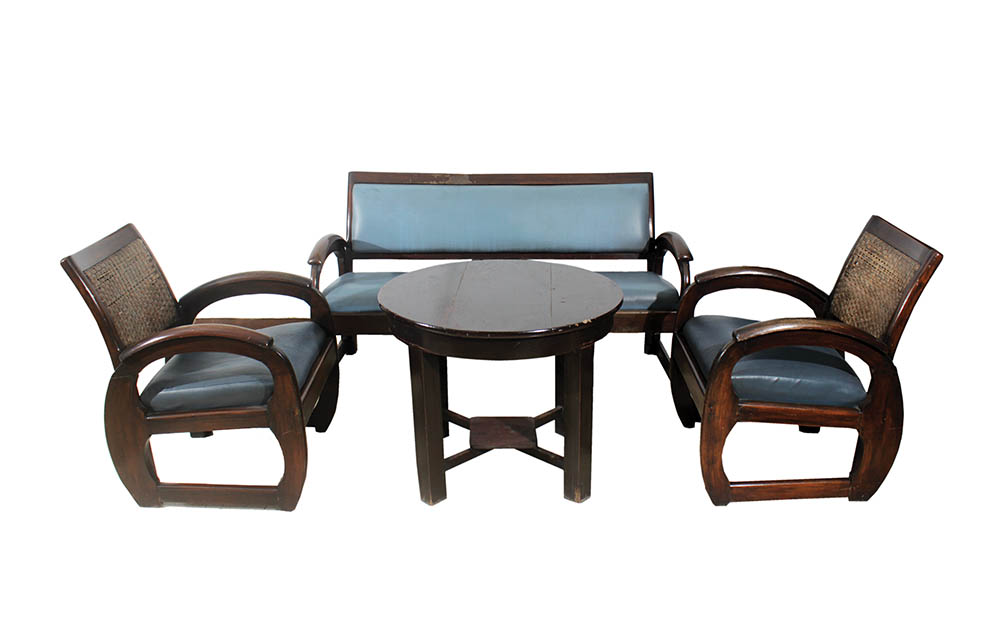 A set of wooden furniture consisting of three-seater sofa, two arm chairs and wooden round table