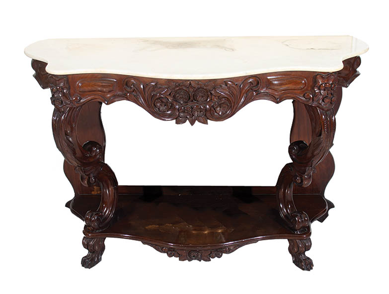 A wooden table with marble top and carved wooden base and legs