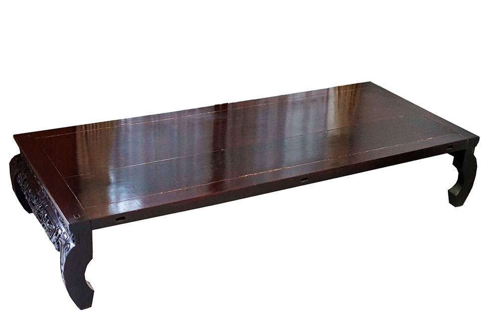 A Chinese wooden low table with carving