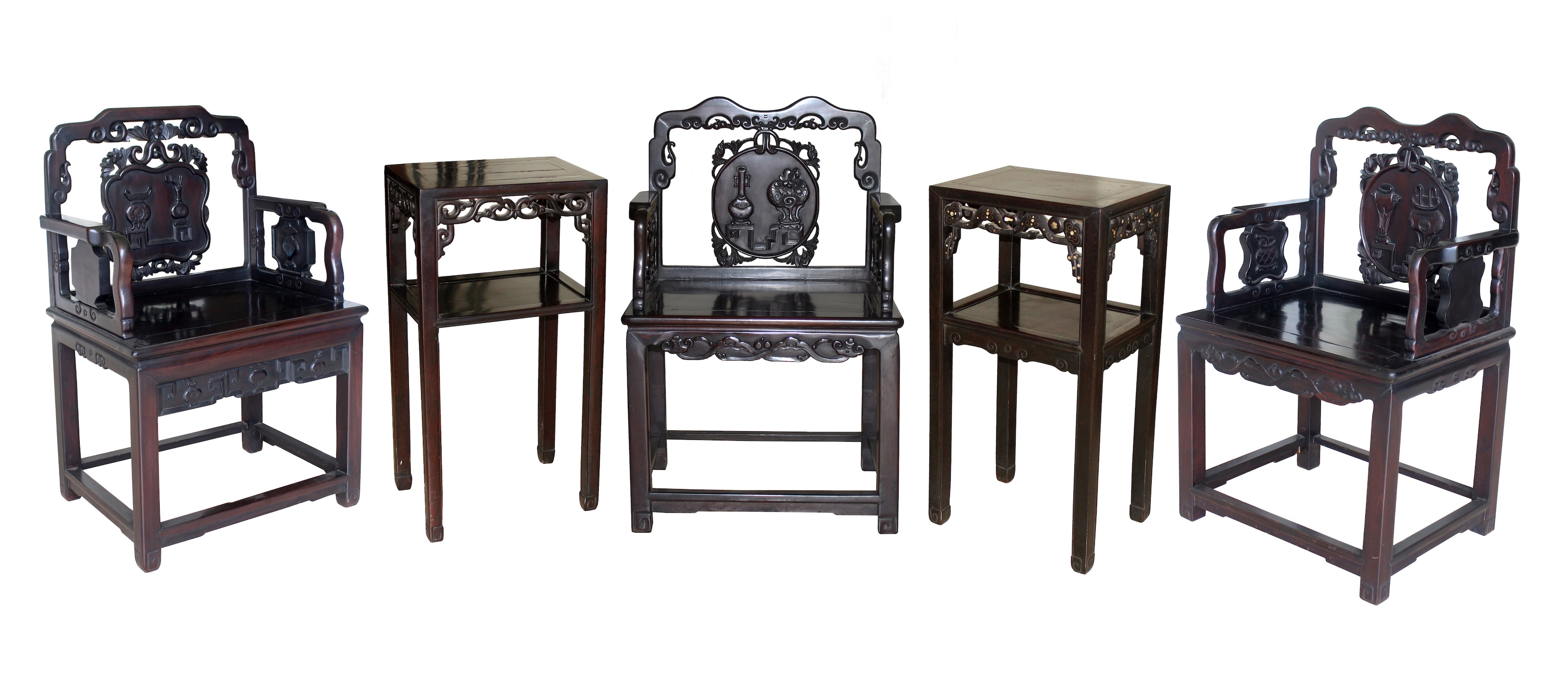 A group of five Chinese carved blackwood consisting of three armchairs and two late Qing tea tables.