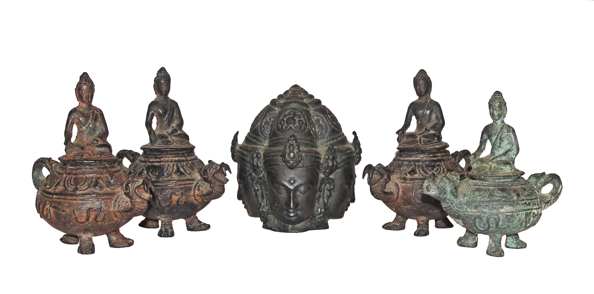 A group of five casted bronze figurines with seated monks on top