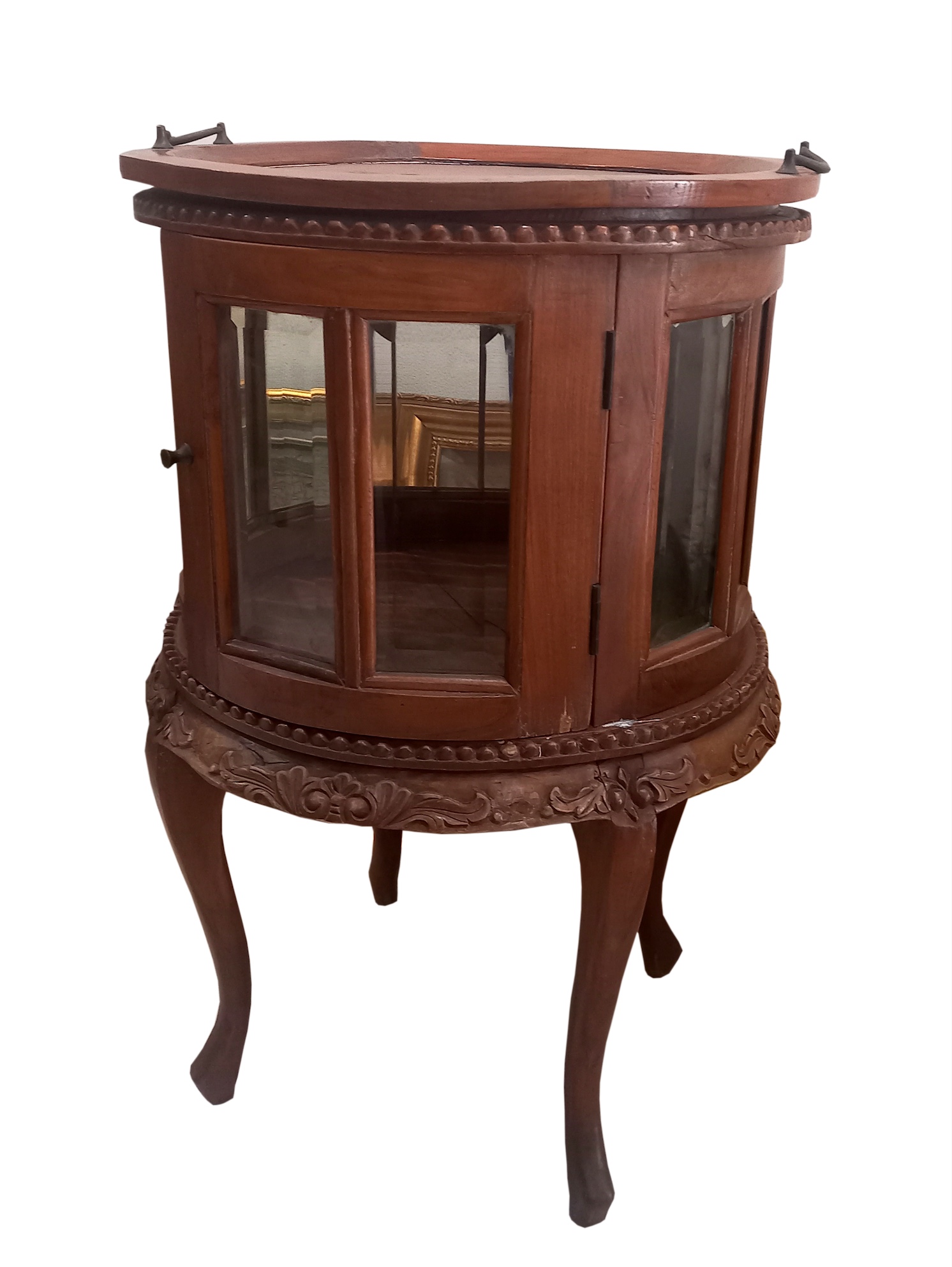 An early 20th century carved teak service table with glass doors panels