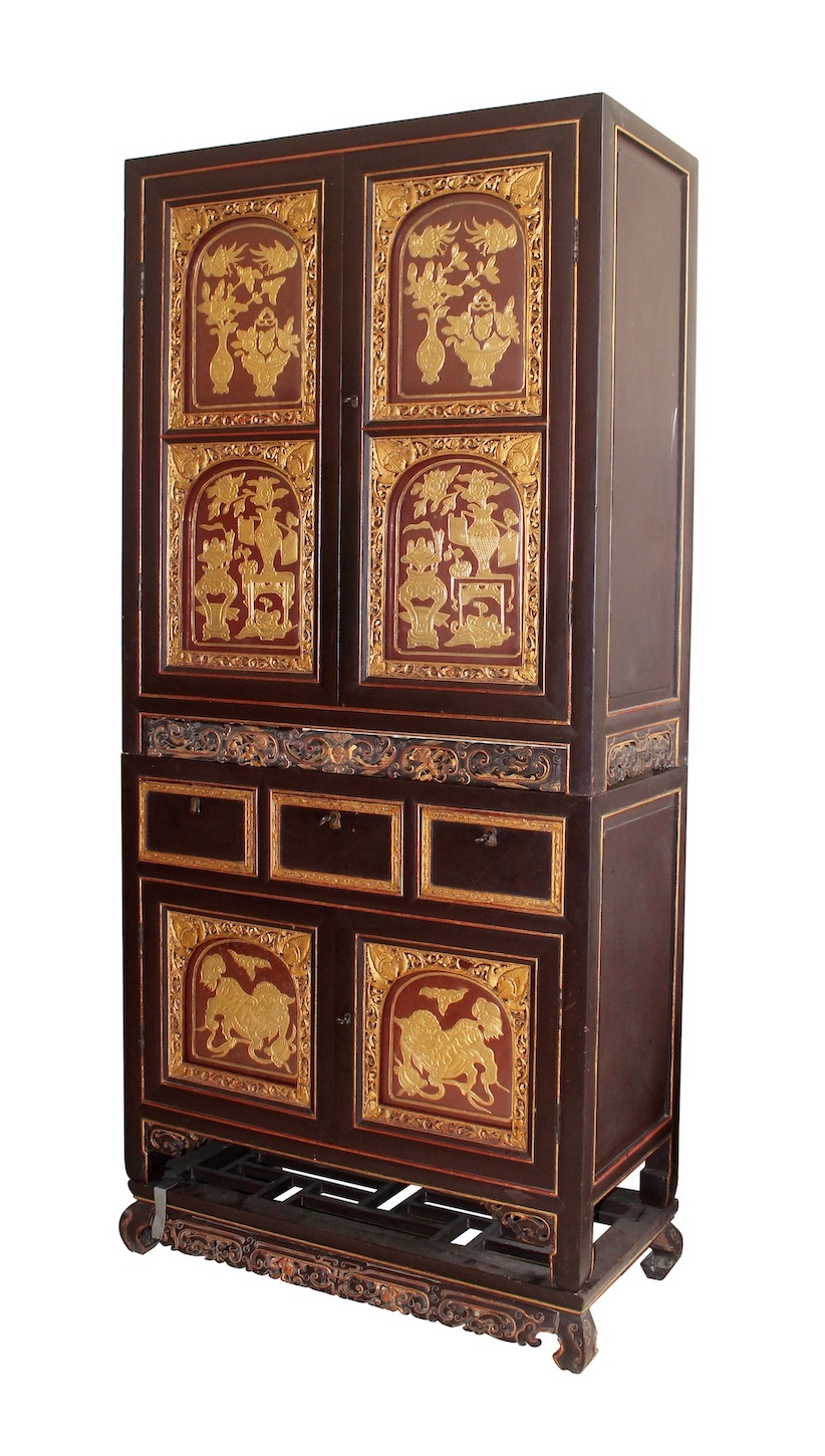 A Late 19th early 20th century Peranakan Chinese Brown and gold carved Tiered cabinet