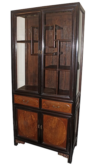 A 20th century carved teak oriental style display cabinet