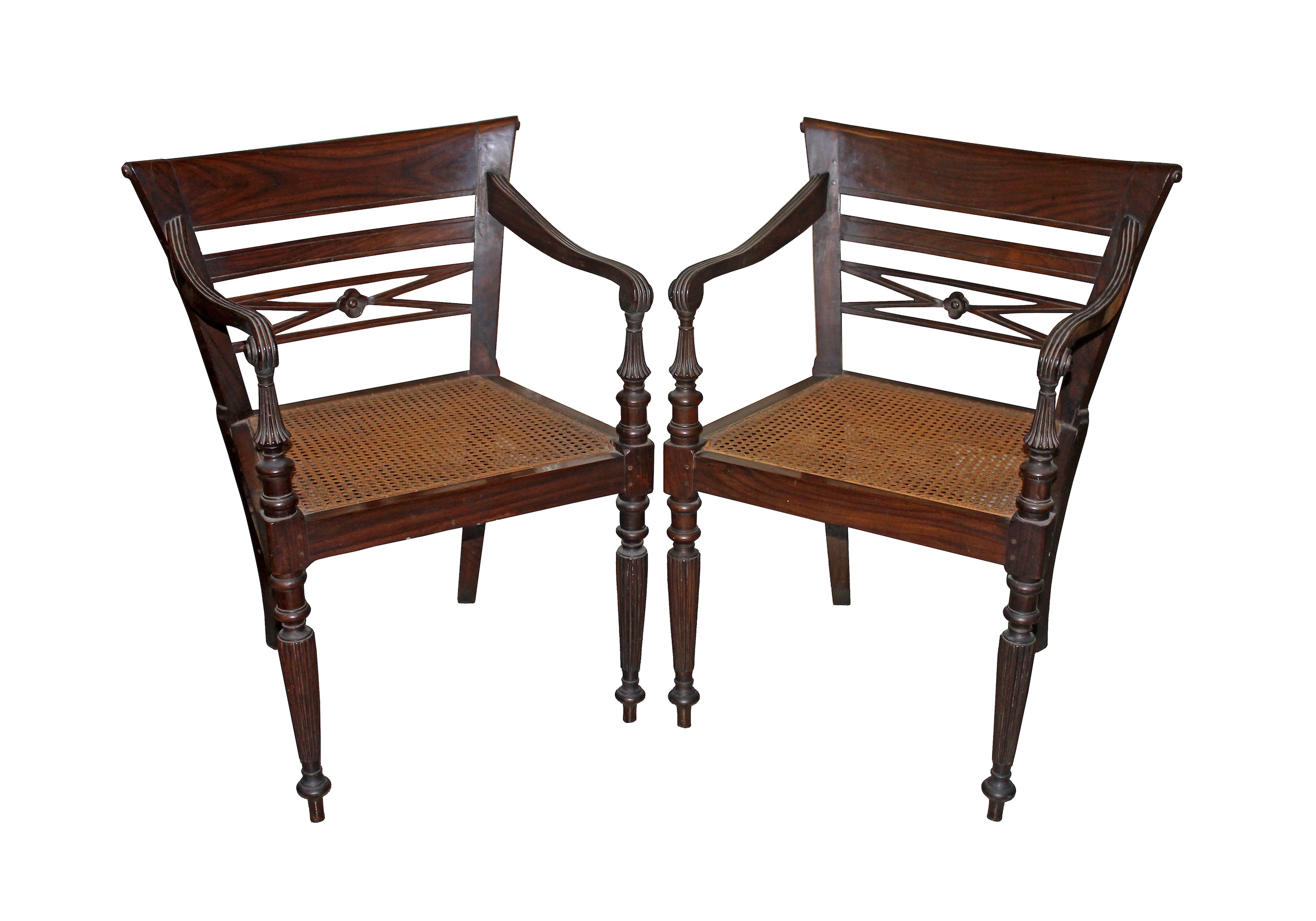 A pair of carved teak armchairs with rattan seat