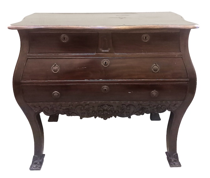 A 20th century carved teak commode with four drawers