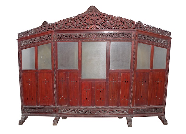 A first half 20th century antique Javanese carved teak screen with glass panel