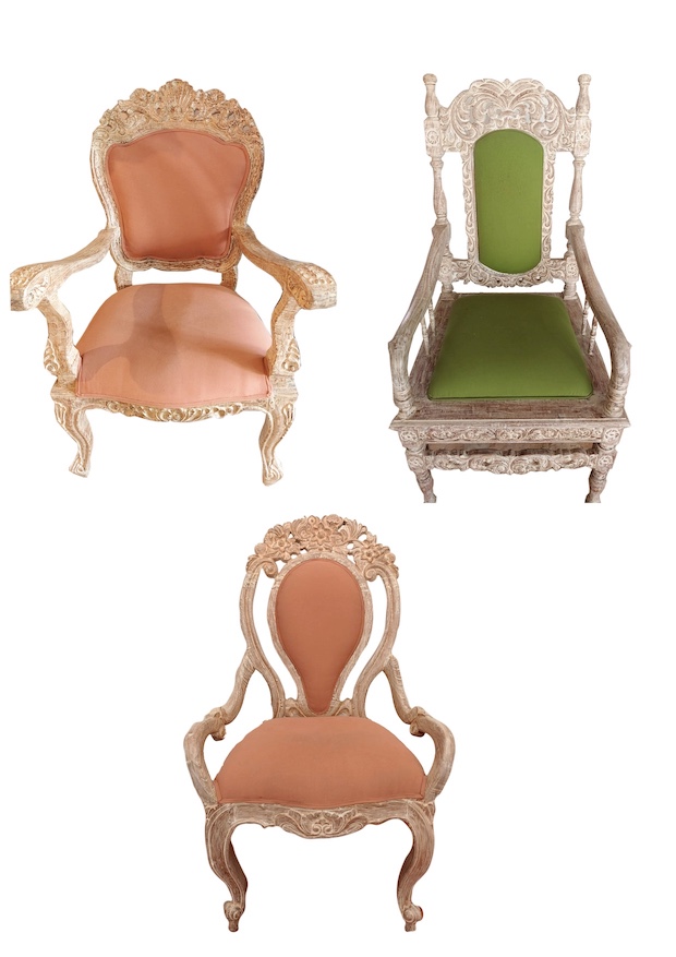 A group of three carved armchairs painted in white