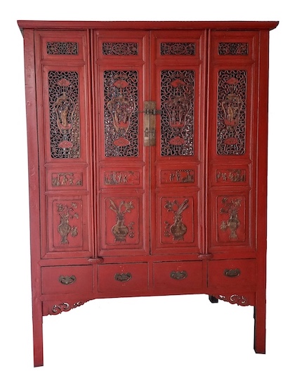 A late 19th century Chinese carved red and gold cupboard with four doors panels