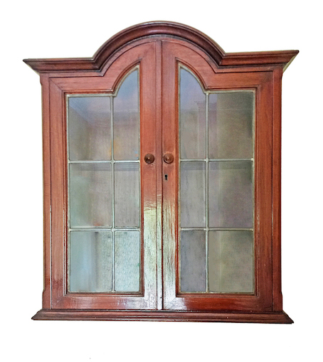An early 20th century carved teak wall cabinet
