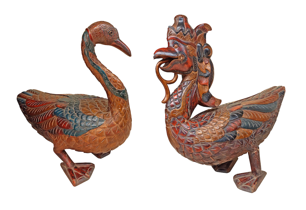 A modern carved wood model of standing ducks