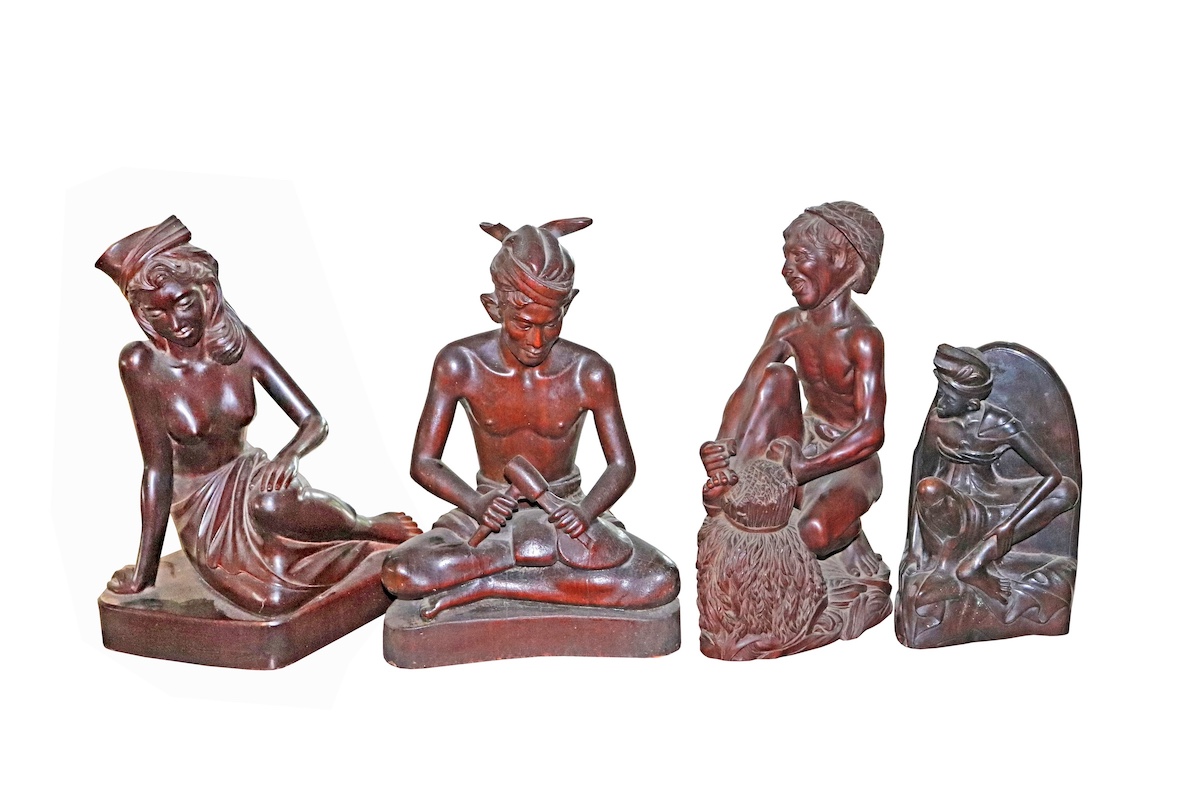 Four pieces of 20th century Balinese carved wood figurines 