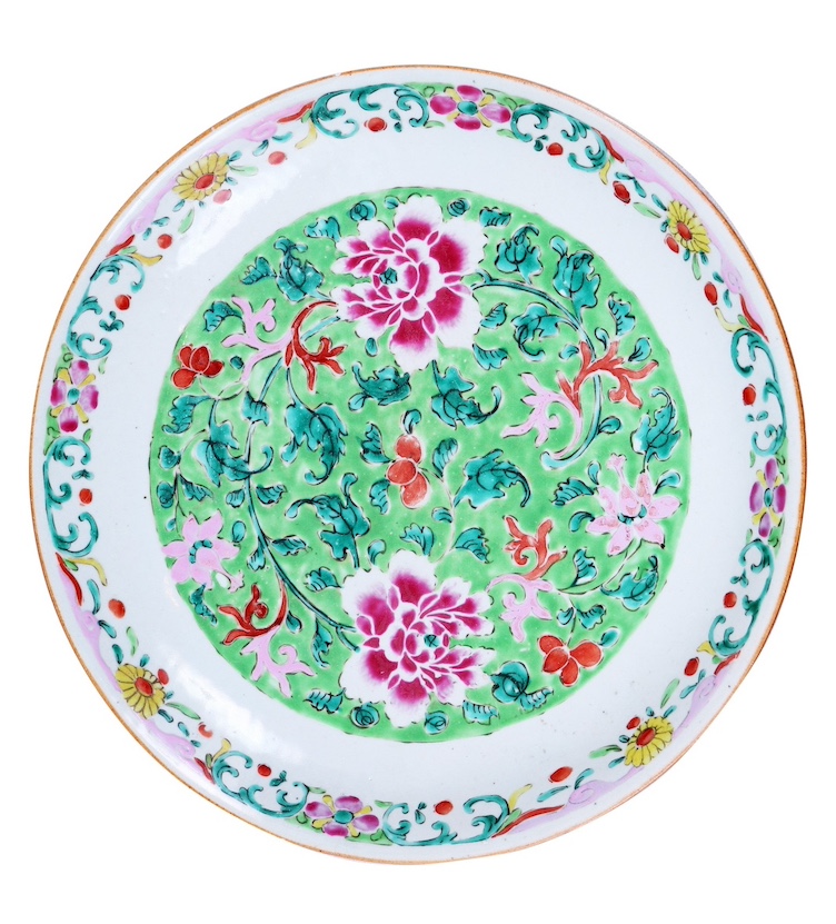 A Qing 18th century Chinese famillie rose dish painted with peony blossom on green ground hairlines