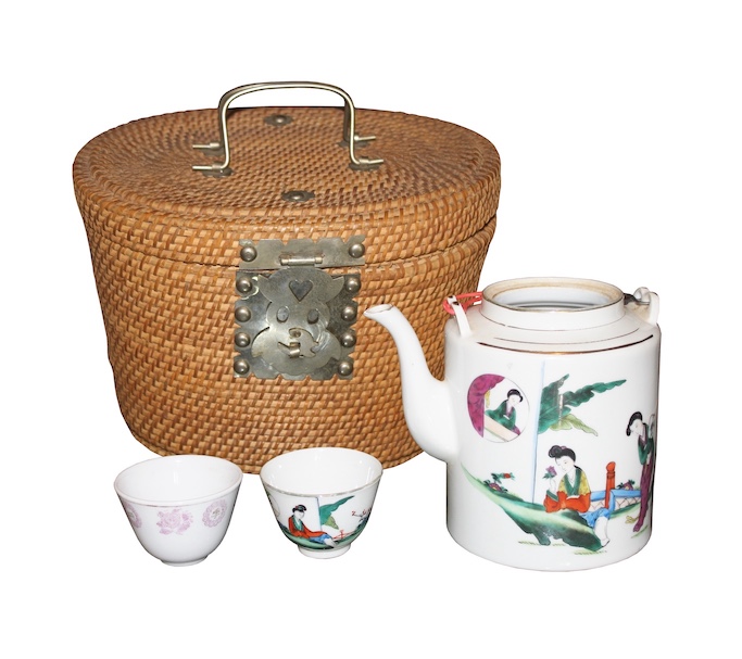A 20th century chinese teapot and two cups with a basket