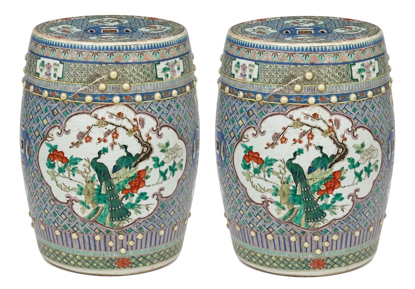 A pair of late qing Chinese famille verte stools painted with peacocks and flowers