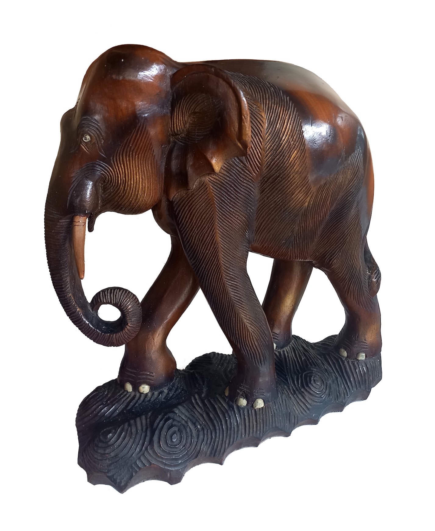 A carved wood model of standing elephant