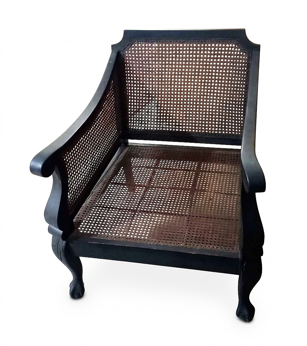 A pair of 19th century carved teak Dutch colonial period armchairs with rattan seat and back