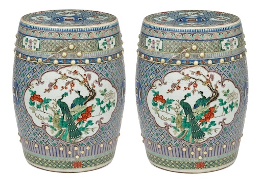 A pair of late qing Chinese famille verte stools painted with peacocks and flowers