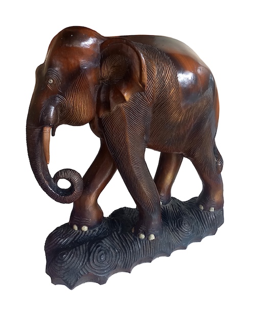 A carved wood model of standing elephant