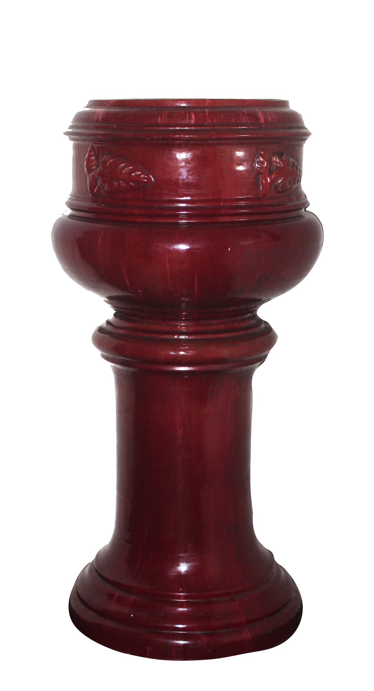 A red glazed ceramic pot and stand