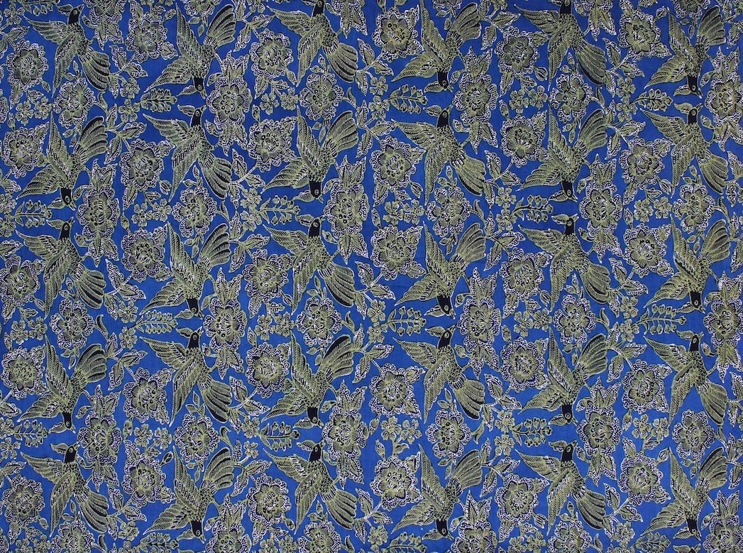 A mix of chanting golden bird motifs on a blue fabric remembering the birds along the coastline of Cirebon.