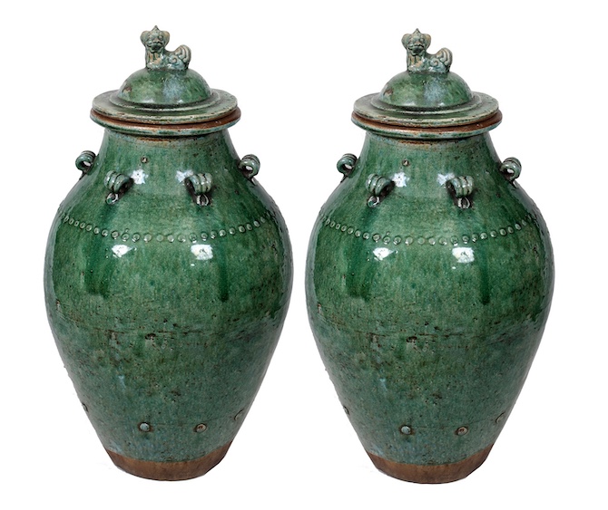 A pair of Qing 19th century Shiwan green glazed covered jar with lion