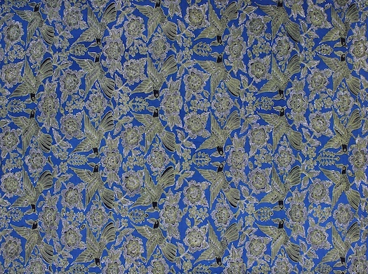 A mix of chanting golden bird motifs on a blue fabric remembering the birds along the coastline of Cirebon.