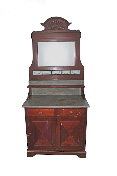 An early 20th century Dutch colonial period carved teak side board with mirror and tiles