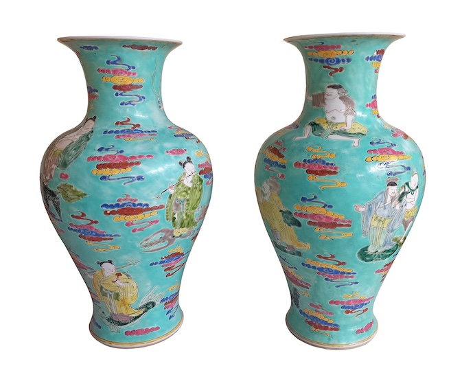A pair of Chinese famille rose turquoise ground vases painted with eight immortals