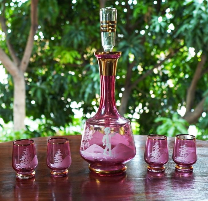 A set of five vintage Mary Gregory consisting of a decanter and four Cranberry glasses