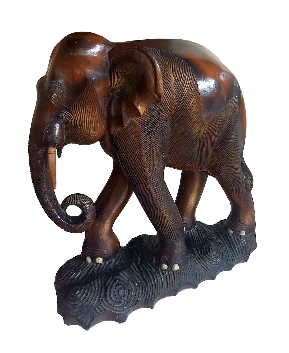 A carved wood model of standing elephant