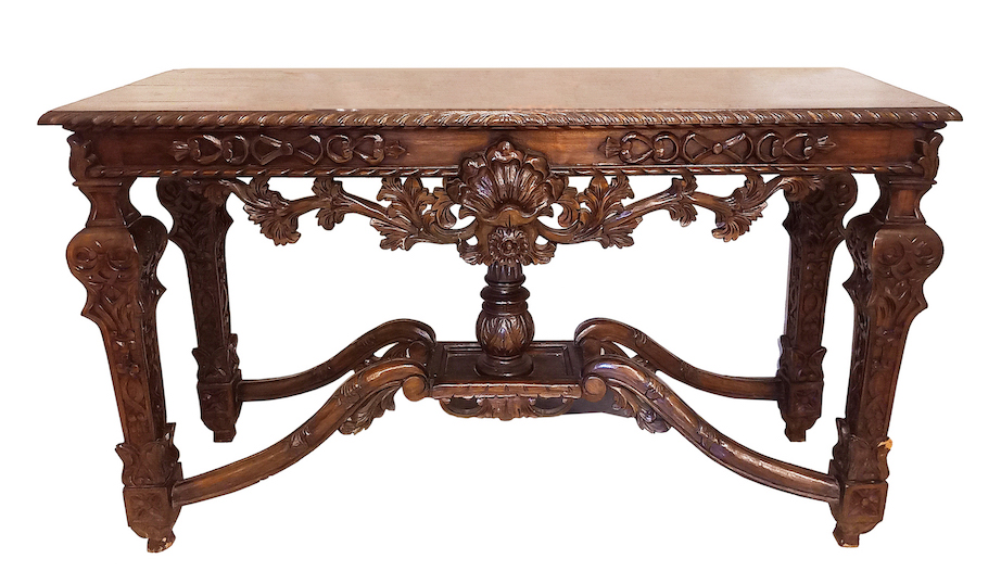A carved baroque style wood table