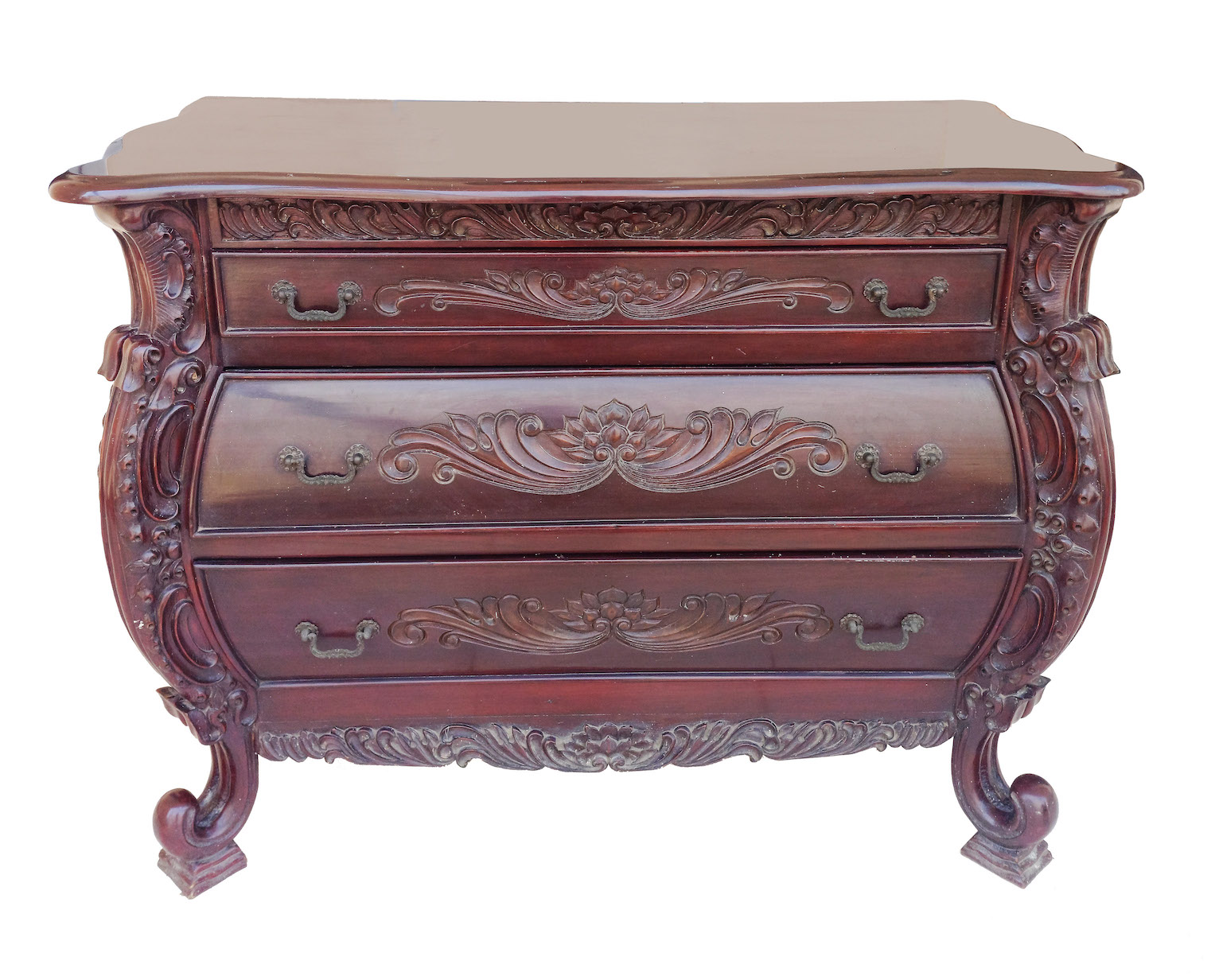 A carved teak commode with three drawers and brass handle