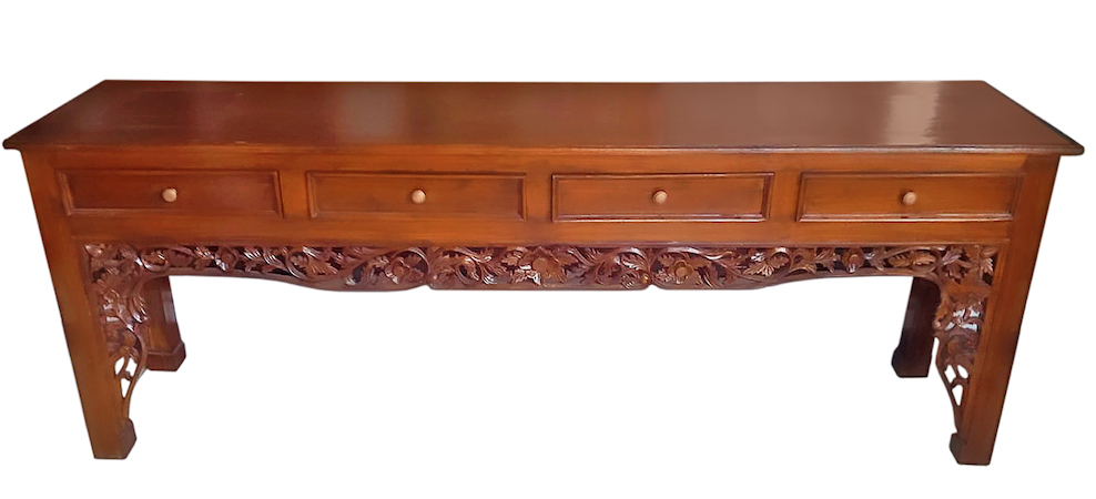 A carved teak side table with four drawers