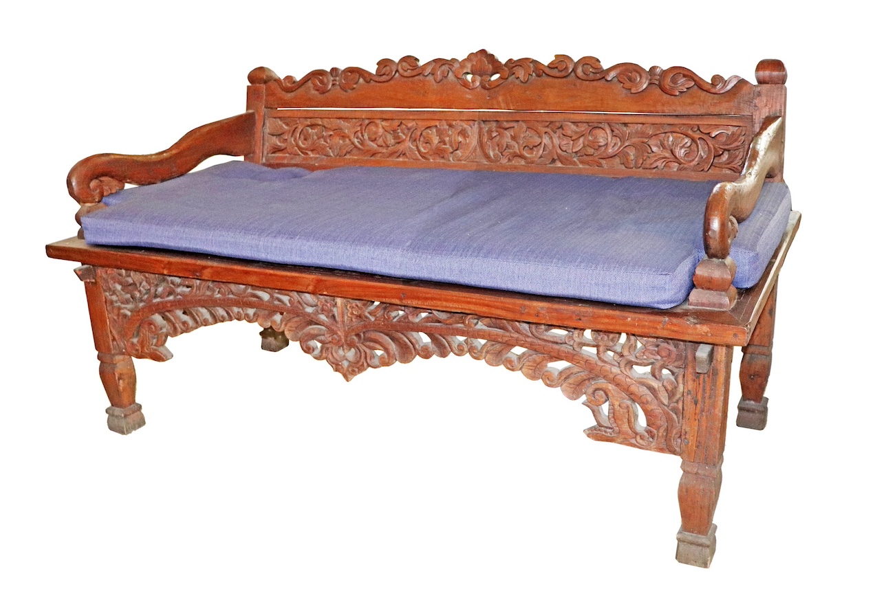 A carved teak sofa