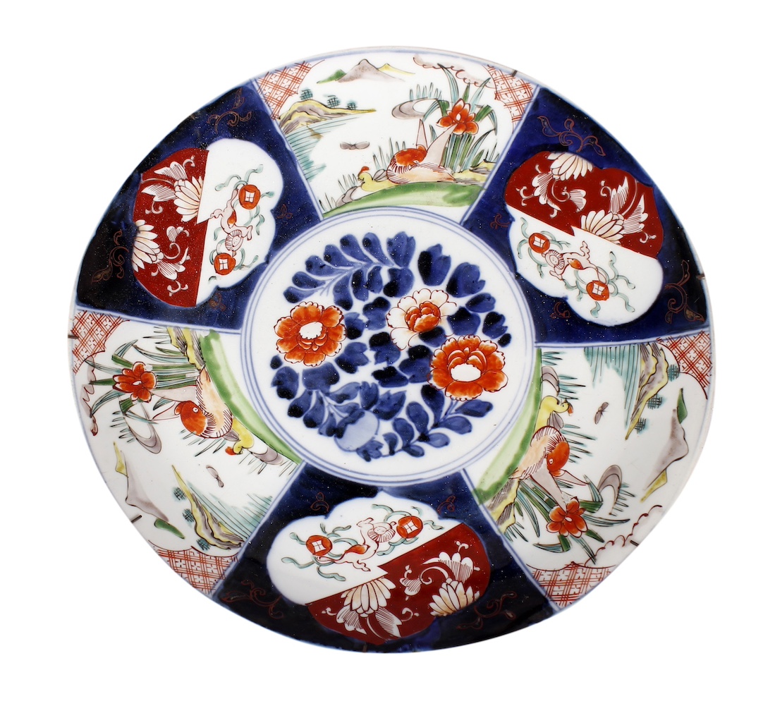 A 19th early 20th century Imari polychrome dish painted with panels of flower and landscape