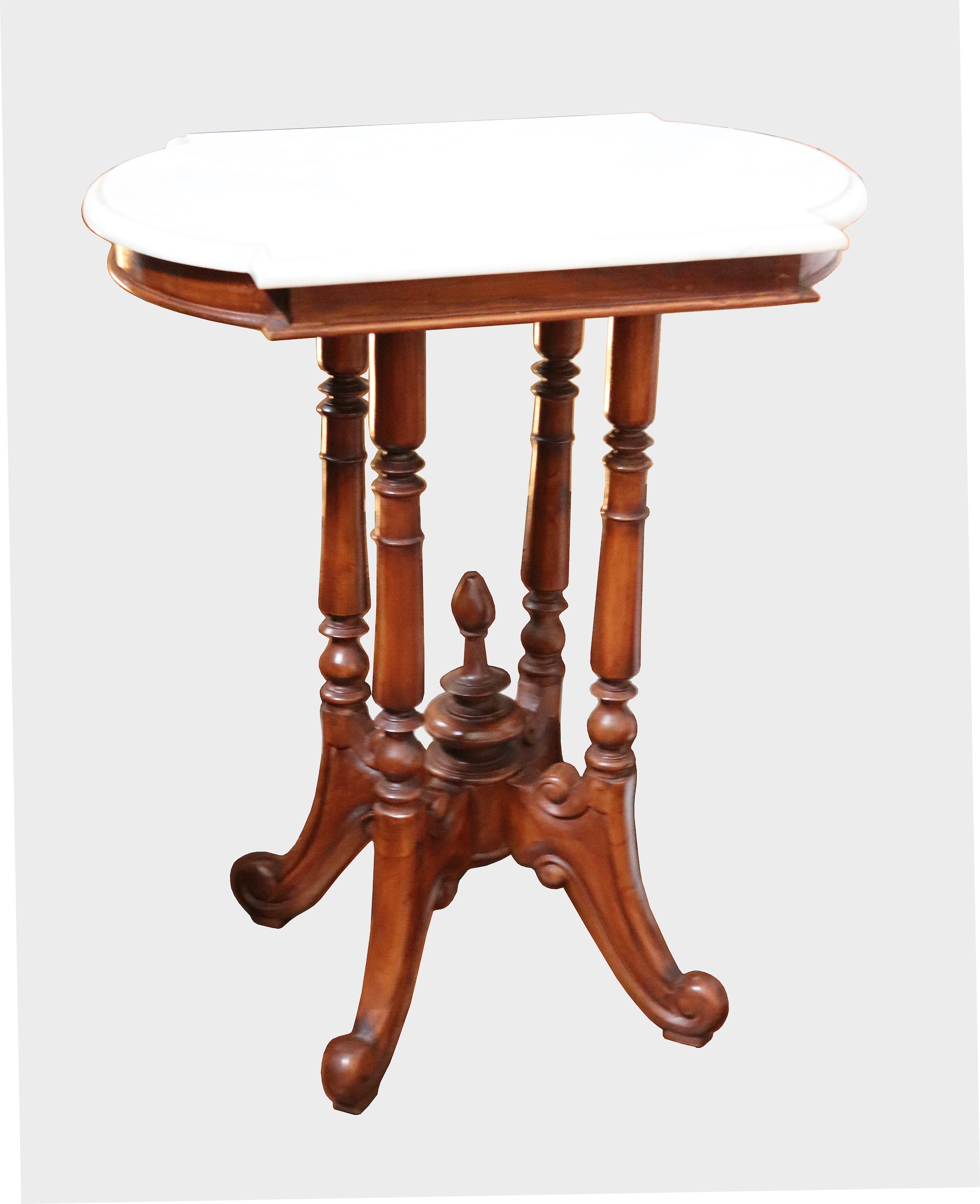 A carved teak gillette form table with marble top