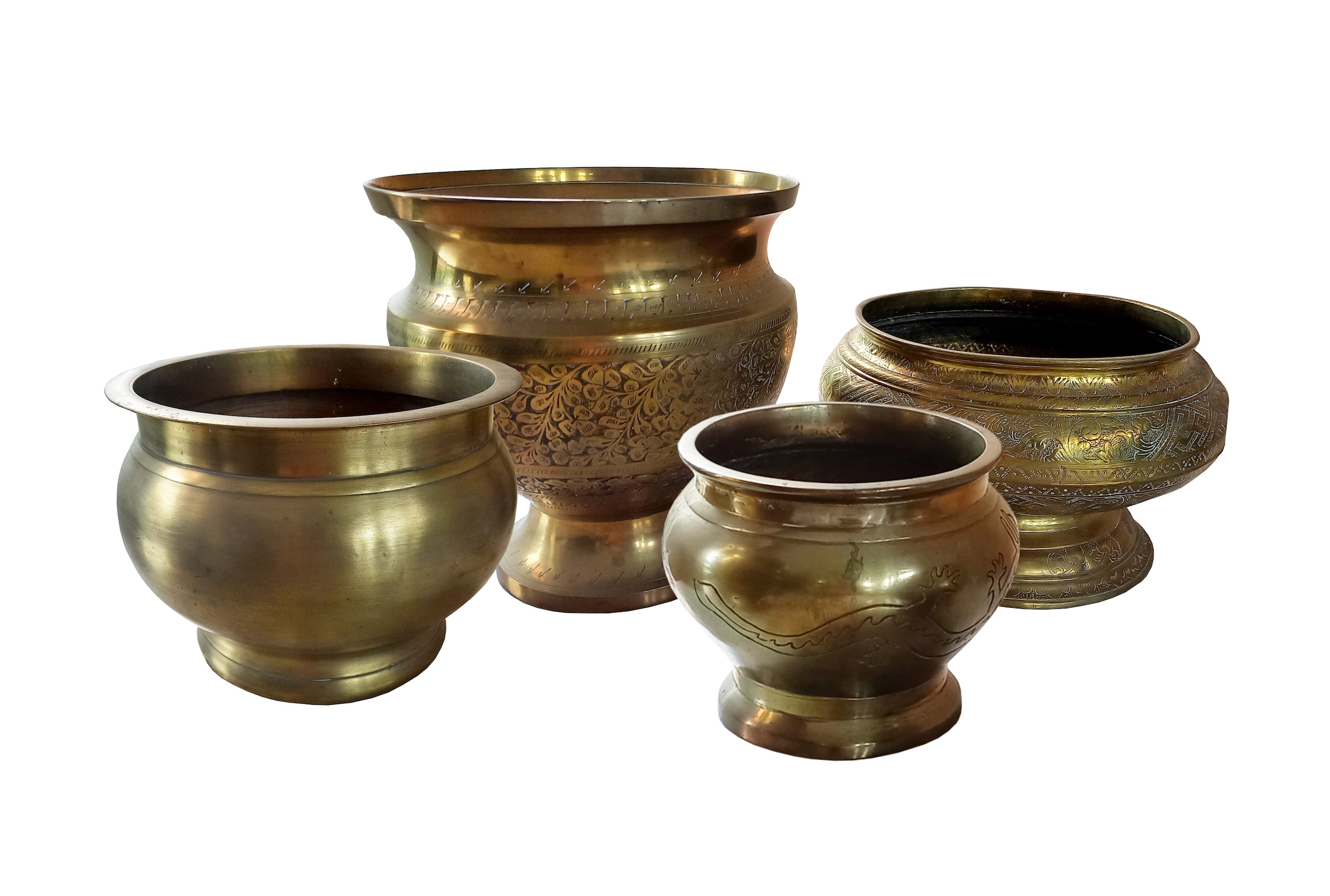 A group of four pieces engraved brass jars