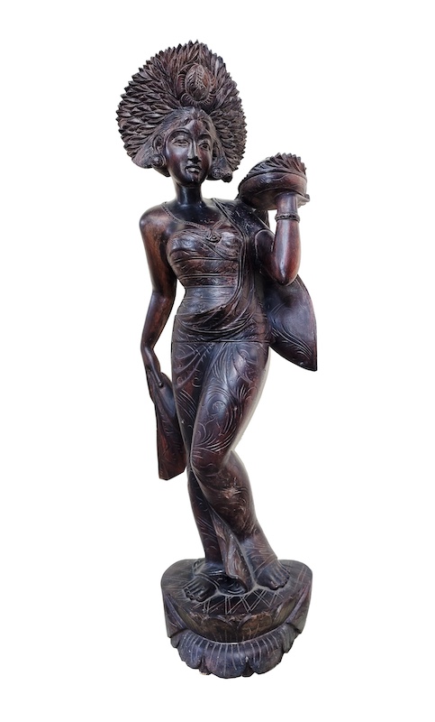 A carved wood figure of standing Balinese dancer
